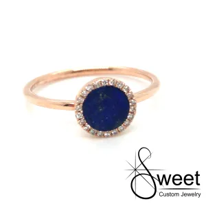 14kt ROSE GOLD RING FEATURING ONE ROUND LAPIS WITH A HALO OF ROUND DIAMONDS .06CTTW